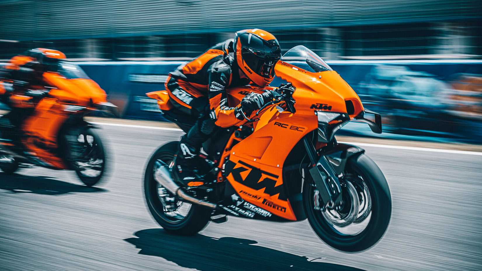 A 2022 KTM RC 8C pulling a wheelie on a racetrack