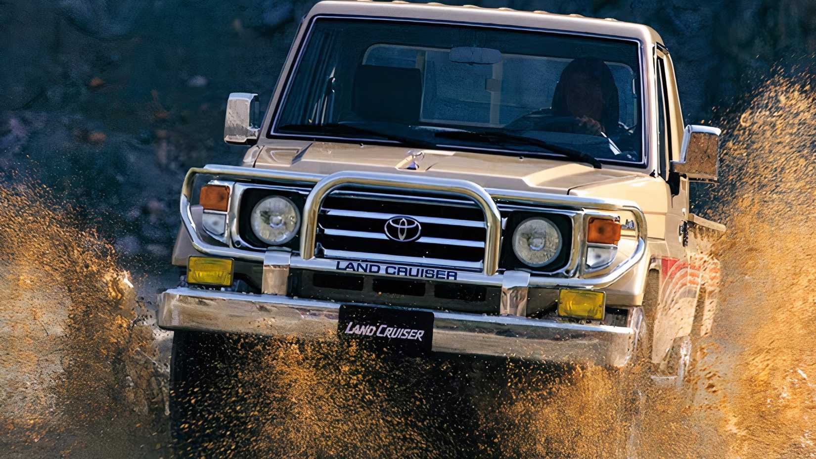 70-Series Toyota Land Cruiser driving through water puddle