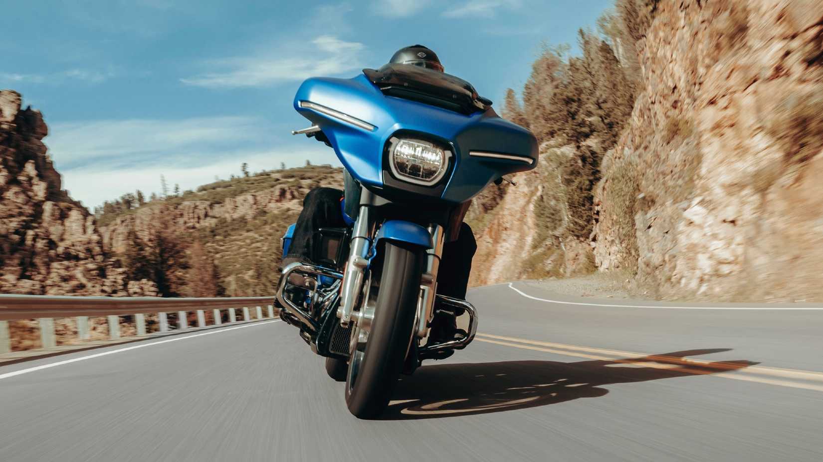 Blue 2026 Harley-Davidson Street Glide Riding through the canyons front panning shot