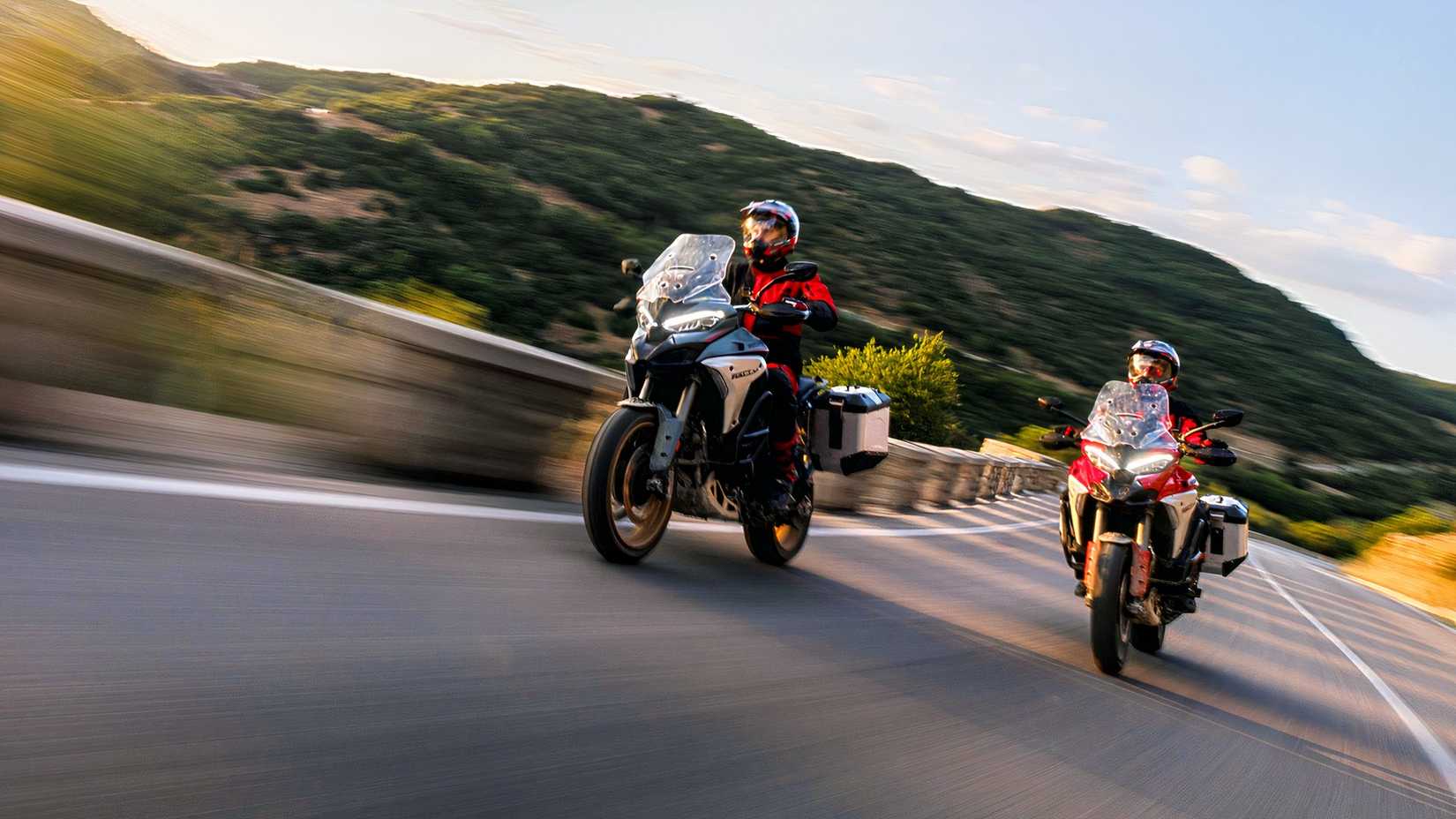 Riders on the Ducati Multistrada V4 Rally riding on twisty roads