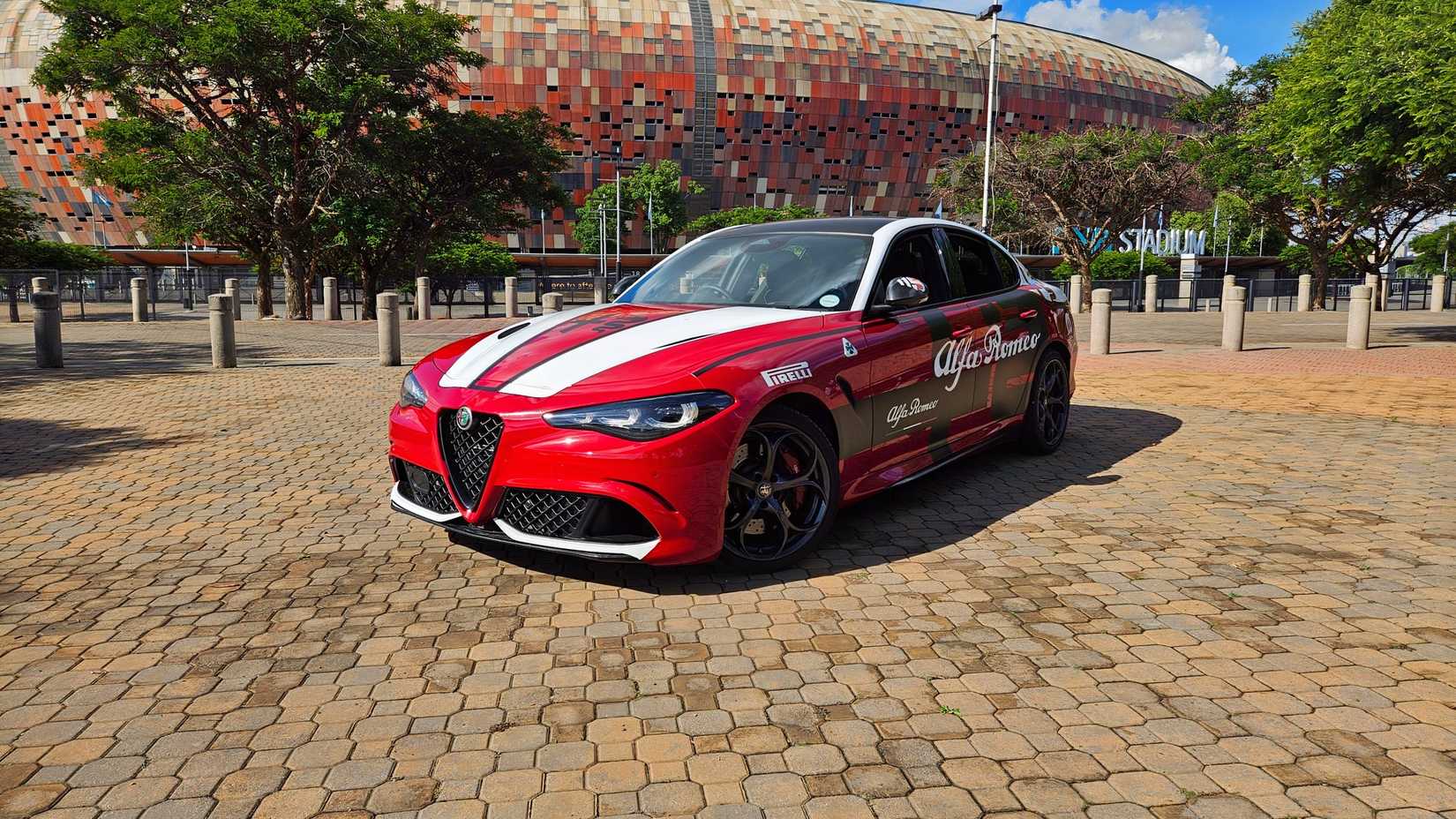 Foto frontal de um Alfa Romeo Giulia Quadrofoglio 2025 em Rosso Red com decalques adesivos