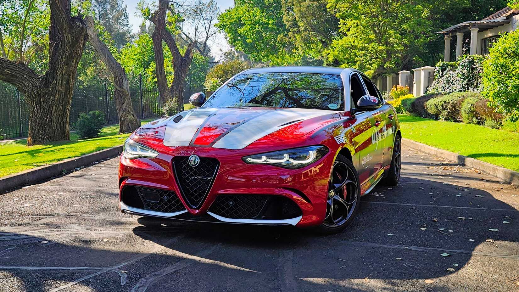 Front shot of a 2025 Alfa Romeo Giulia Quadrofoglio in Rosso Red with sticker decals 