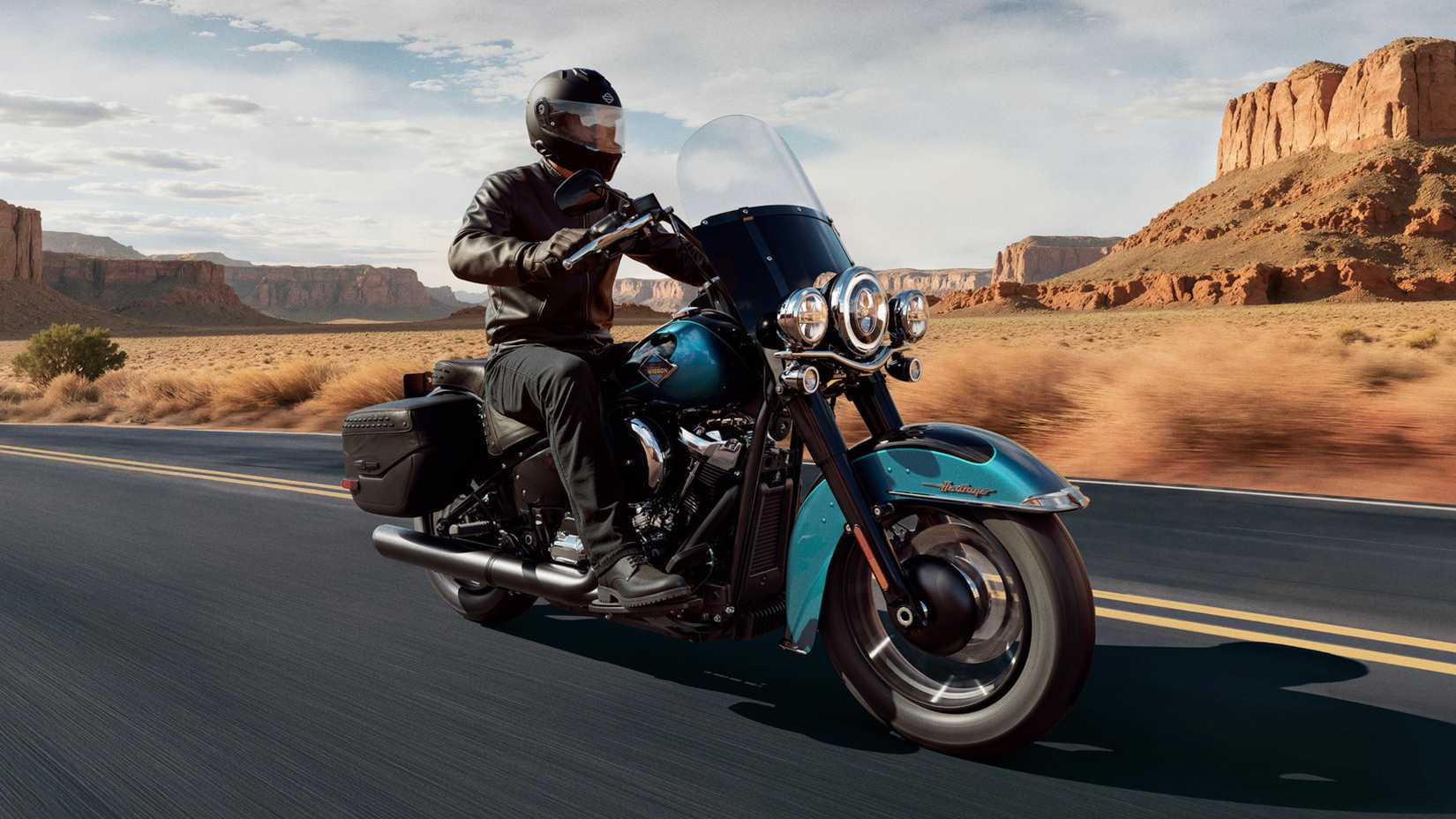 Rider cruising on the open road with the 2026 Harley-Davidson Heritage Classic