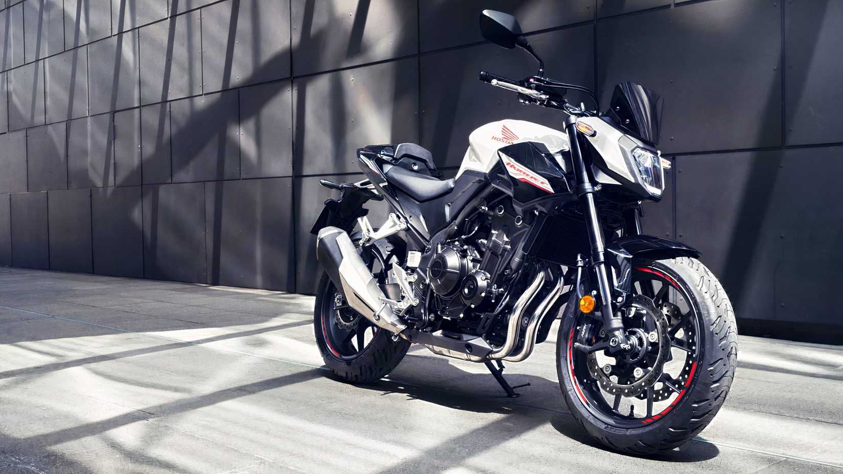 White Honda CB500 Hornet parked beside a building