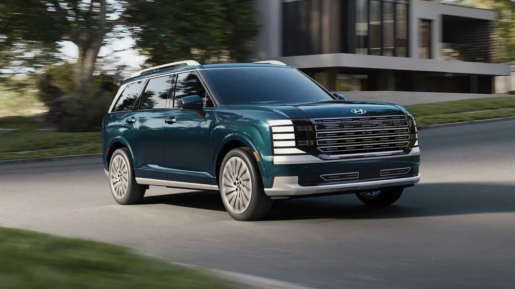 Front 3/4 action shot of 2026 Hyundai Palisade driving on road