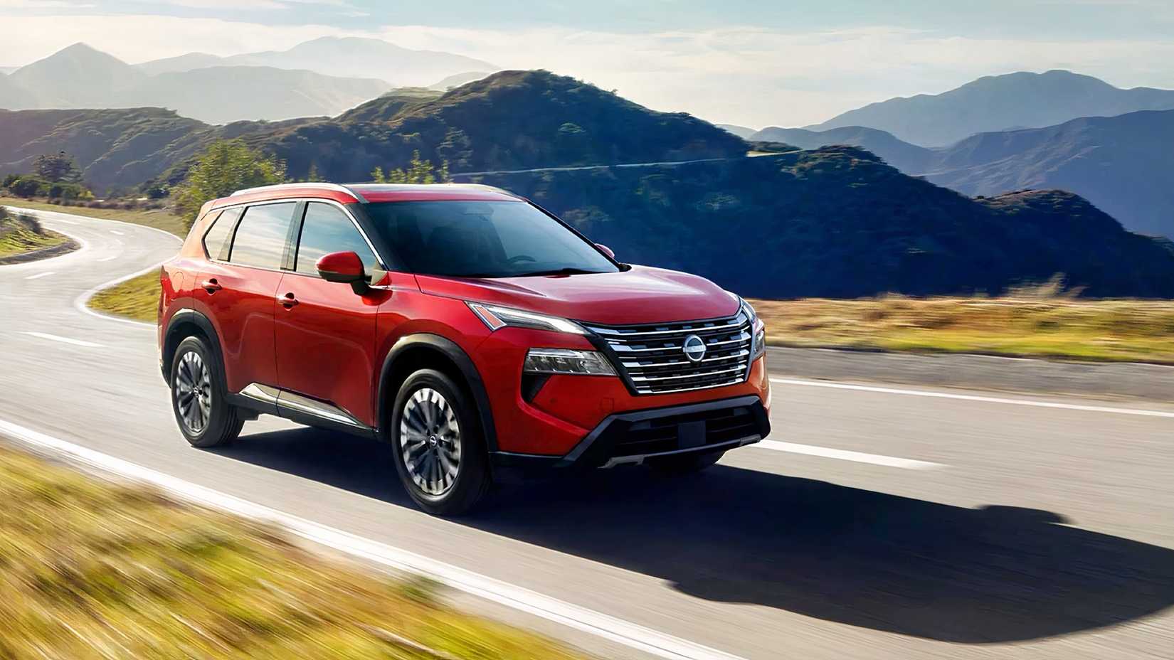 Front 3/4 action shot of 2026 Nissan Rogue driving on road