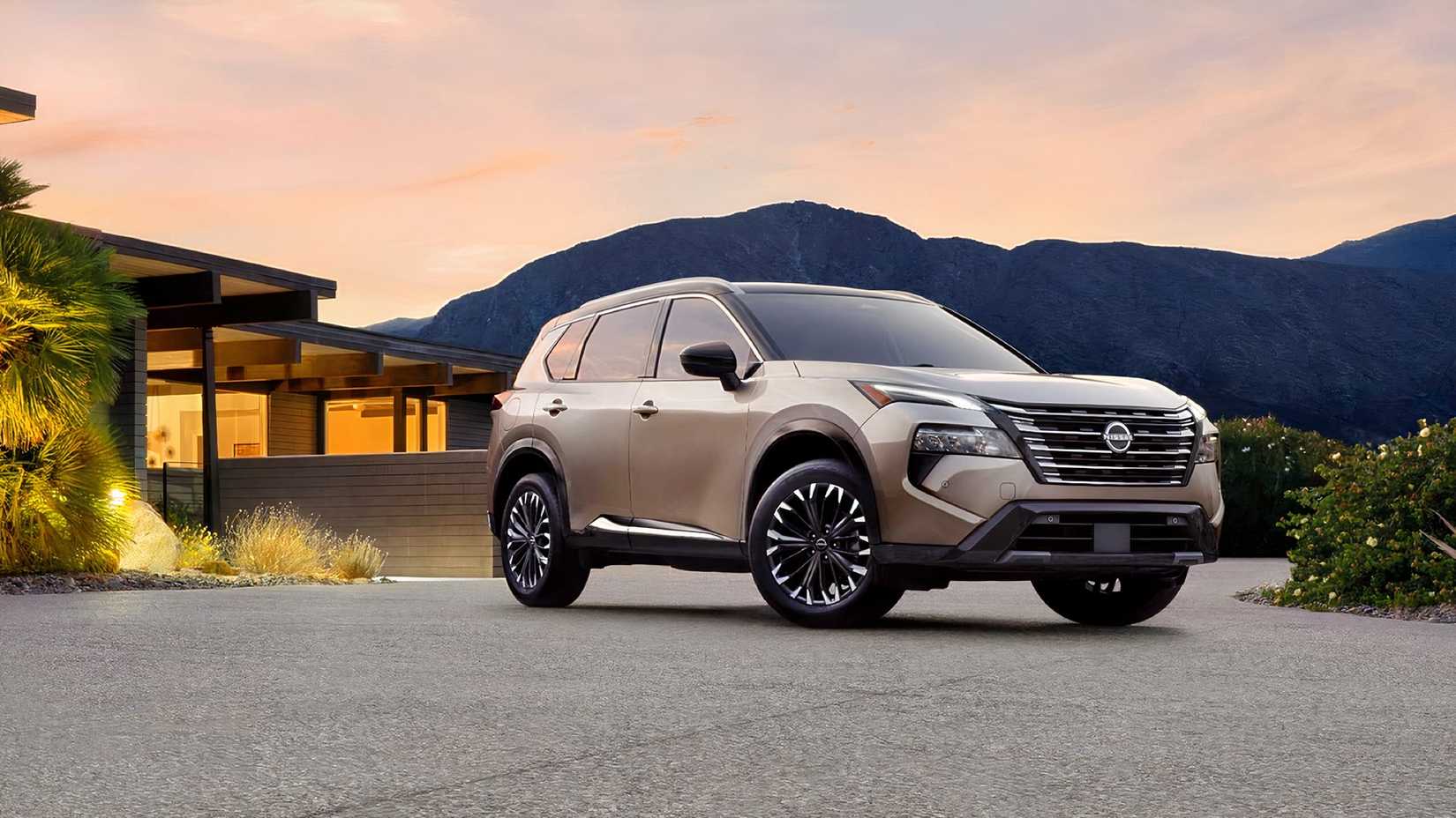 2026 Nissan Rogue front 3/4 parked in front of house