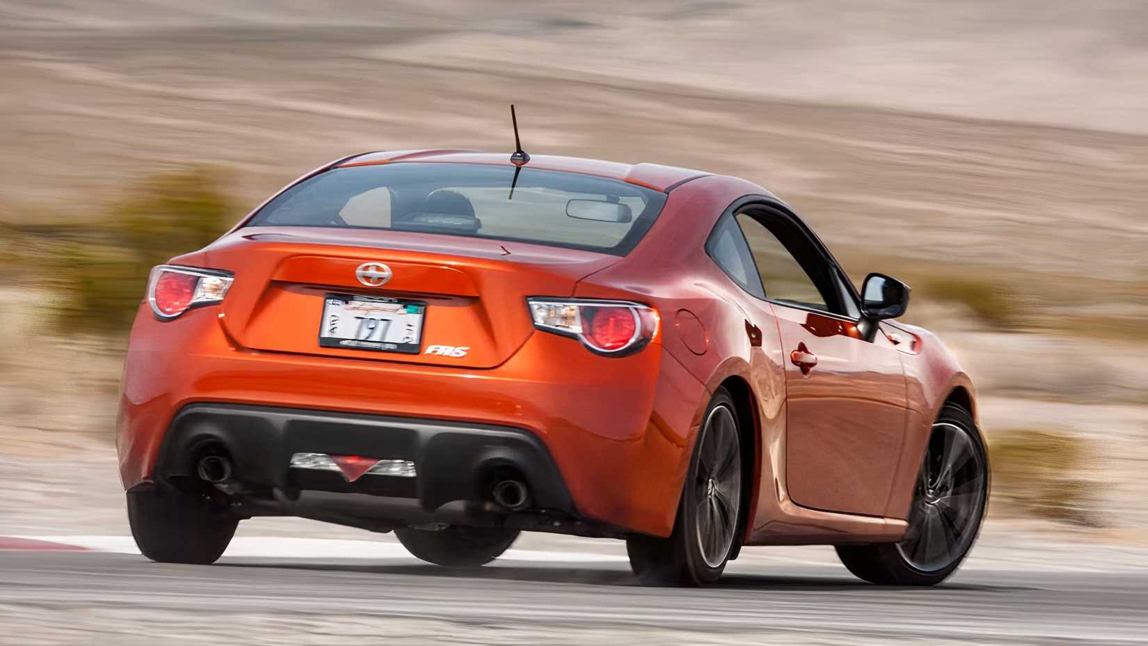 Rear 3/4 action shot of 2016 Scion FR-S driving
