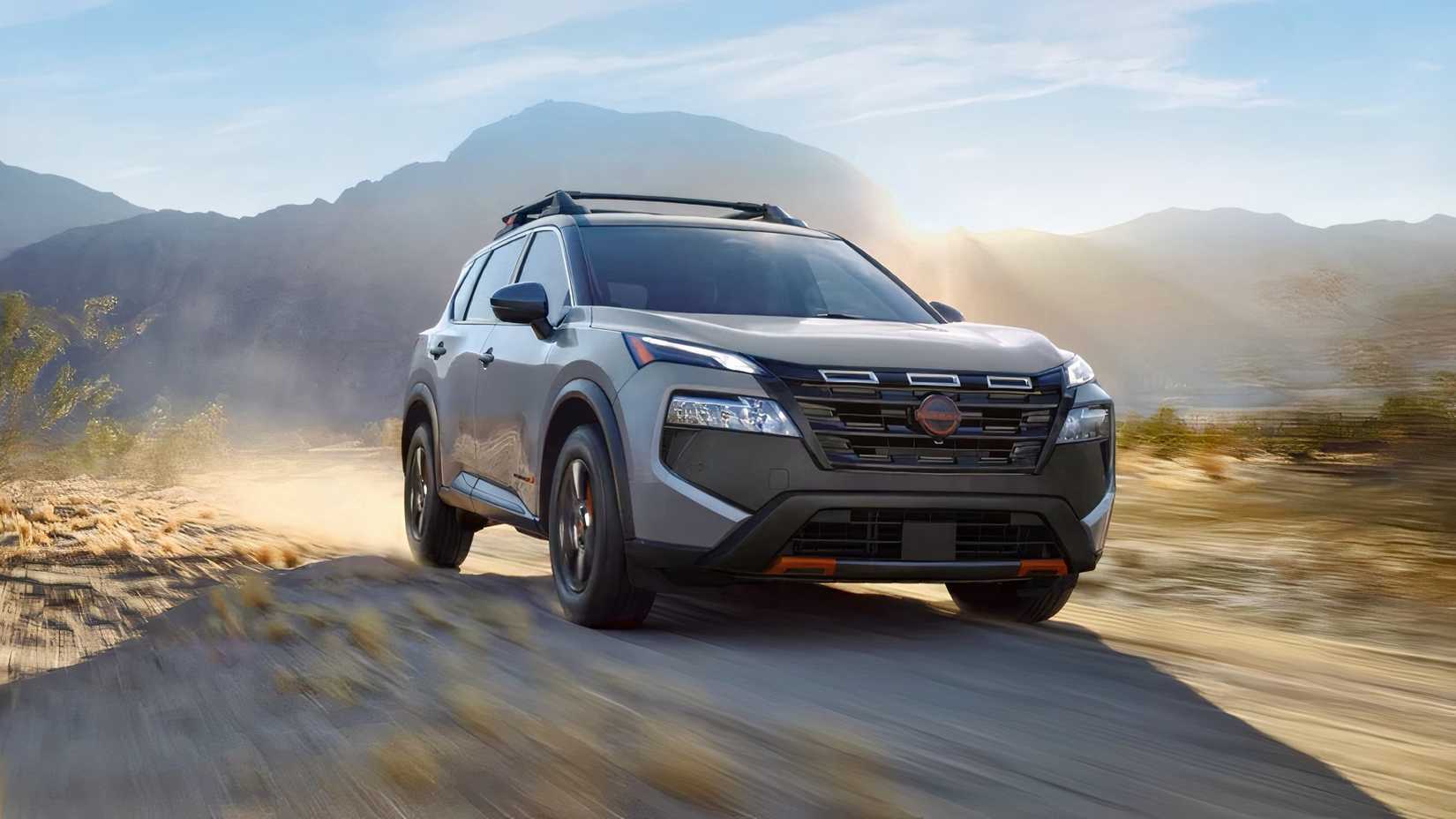 Front 3/4 action shot of 2026 Nissan Rogue Rock Creek driving off-road