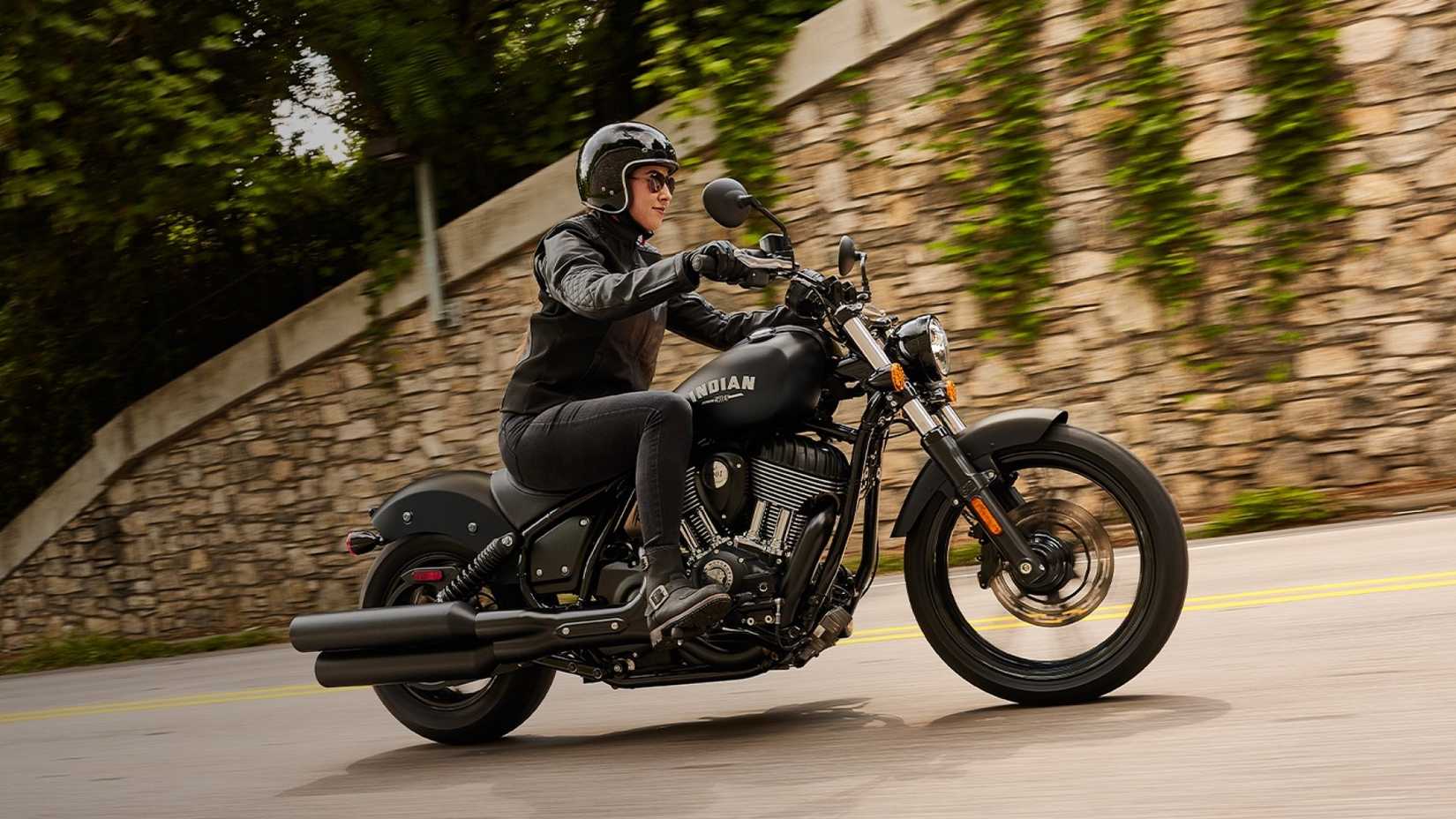 2026 Indian Chief accelerating on city roads front third quarter view