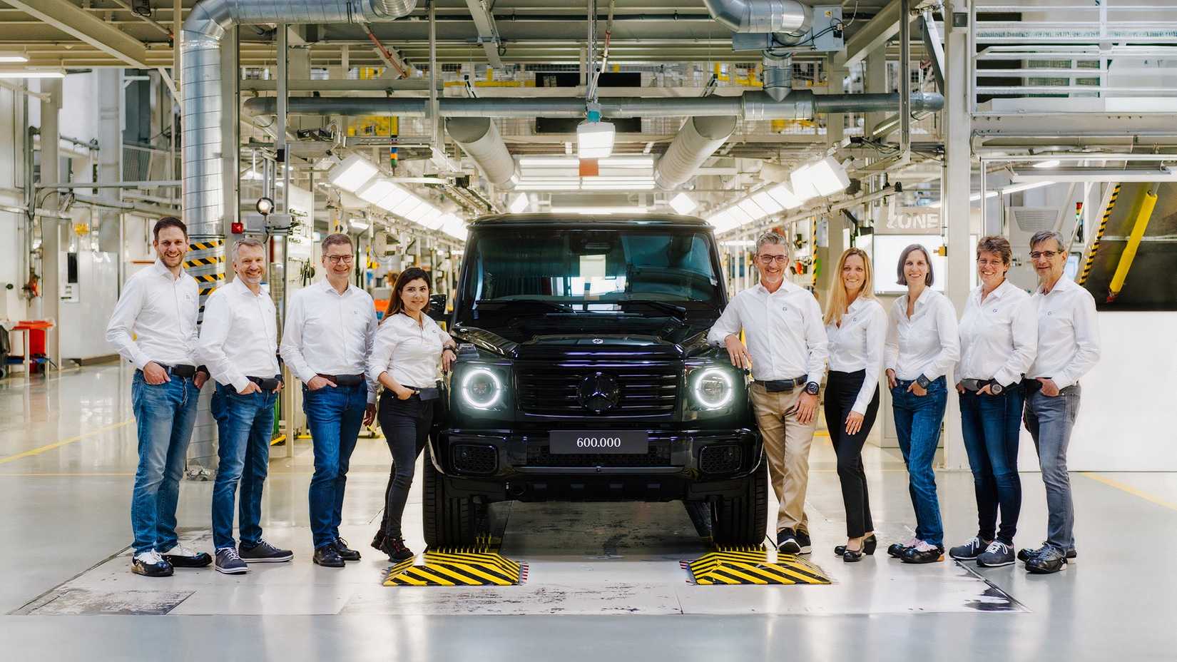 Mercedes-Benz officials pose next to the 600,000th G-Class unit, a G 580 EQ, at the Graz plant in Austria.