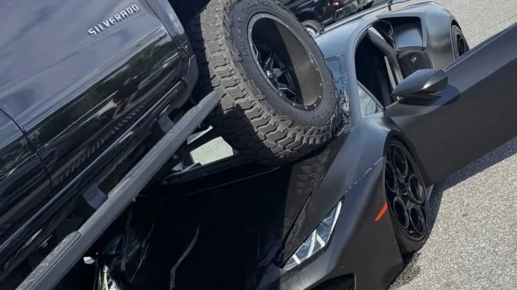 Lifted truck drives over Lamborghini Huracan