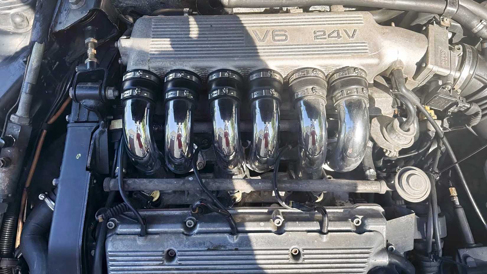 Overhead shot of a 1995 Alfa Romeo 164 showing the engine