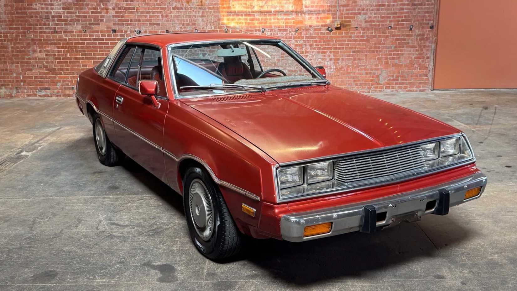 Front 3/4 shot of a 1978 Plymouth Sapporo parked in a garage