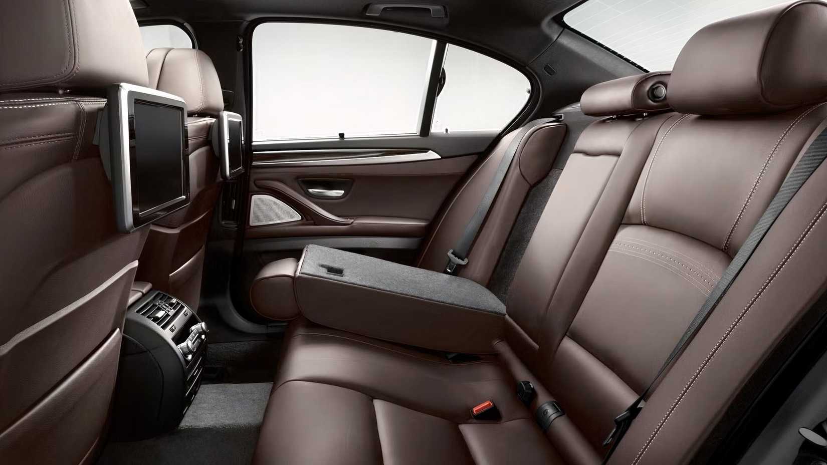 Foto do interior de um BMW Série 5 2016 mostrando as telas dos bancos traseiros