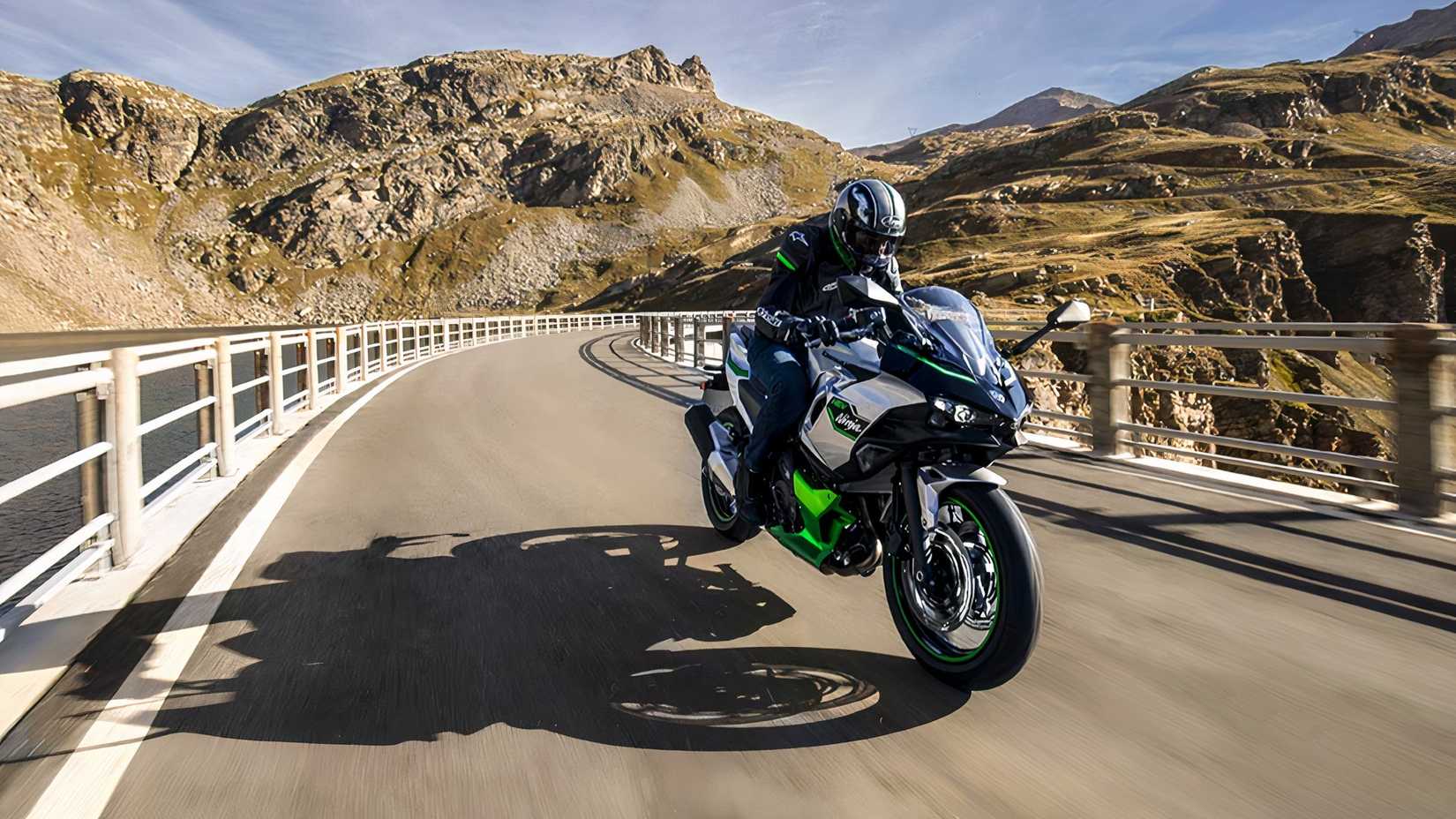 Front shot of a 2024 Kawasaki Ninja 7 Hybrid riding over bridge
