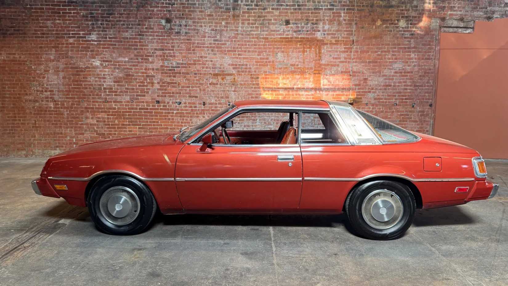 Side shot of a 1978 Plymouth Sapporo parked in garage