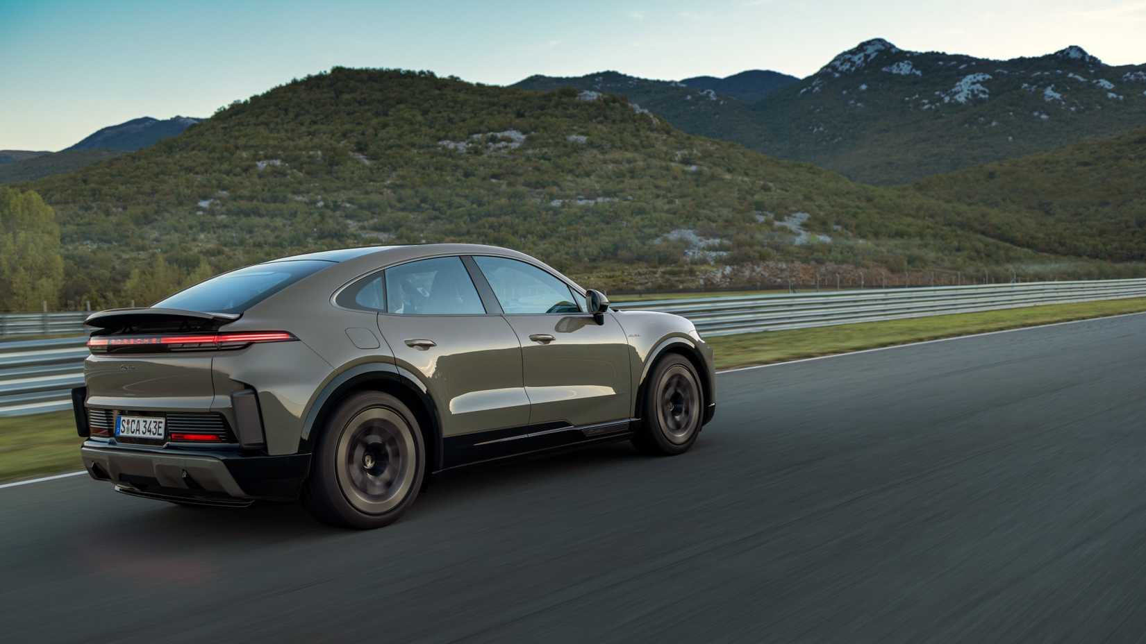 Side shot of a 2026 Porsche Cayenne Coupe Electric driving on track