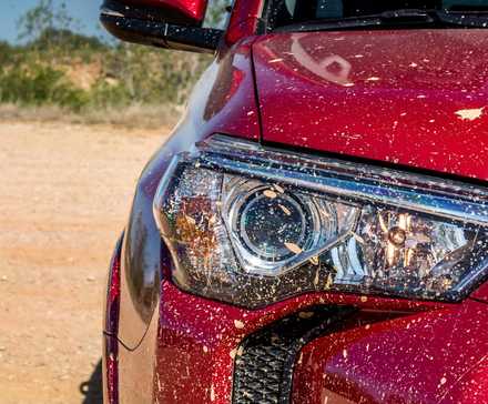 Front close-up of a red 2017 Toyota 4Runner's headlight