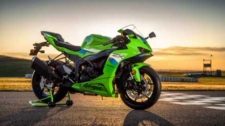Front 3/4 shot of the 2026 Kawasaki Ninja ZX-6R parked on the track