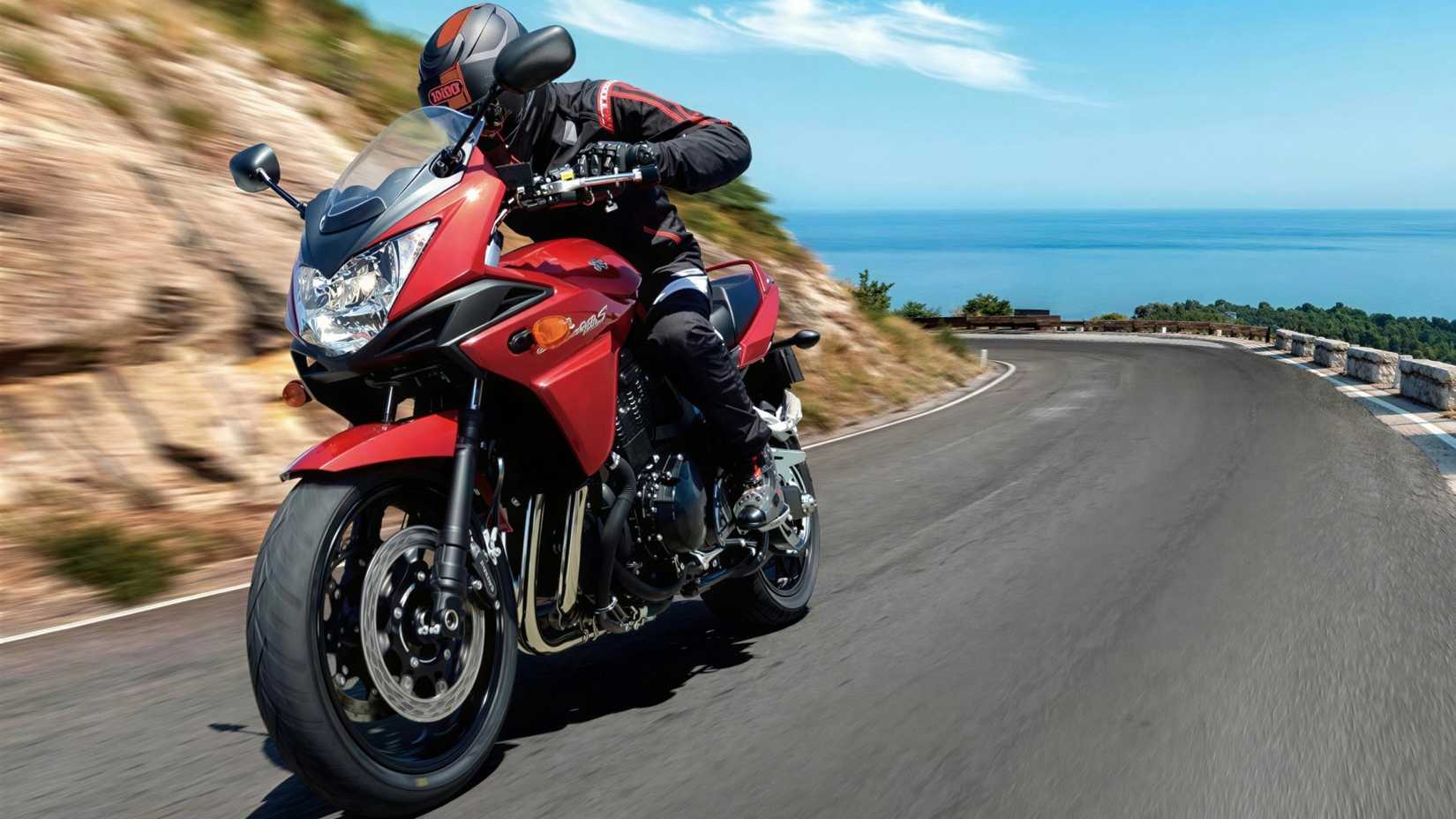 2007 Suzuki Bandit GSF1250S accelerating along a winding mountain road cinematic front third quarter close-up shot