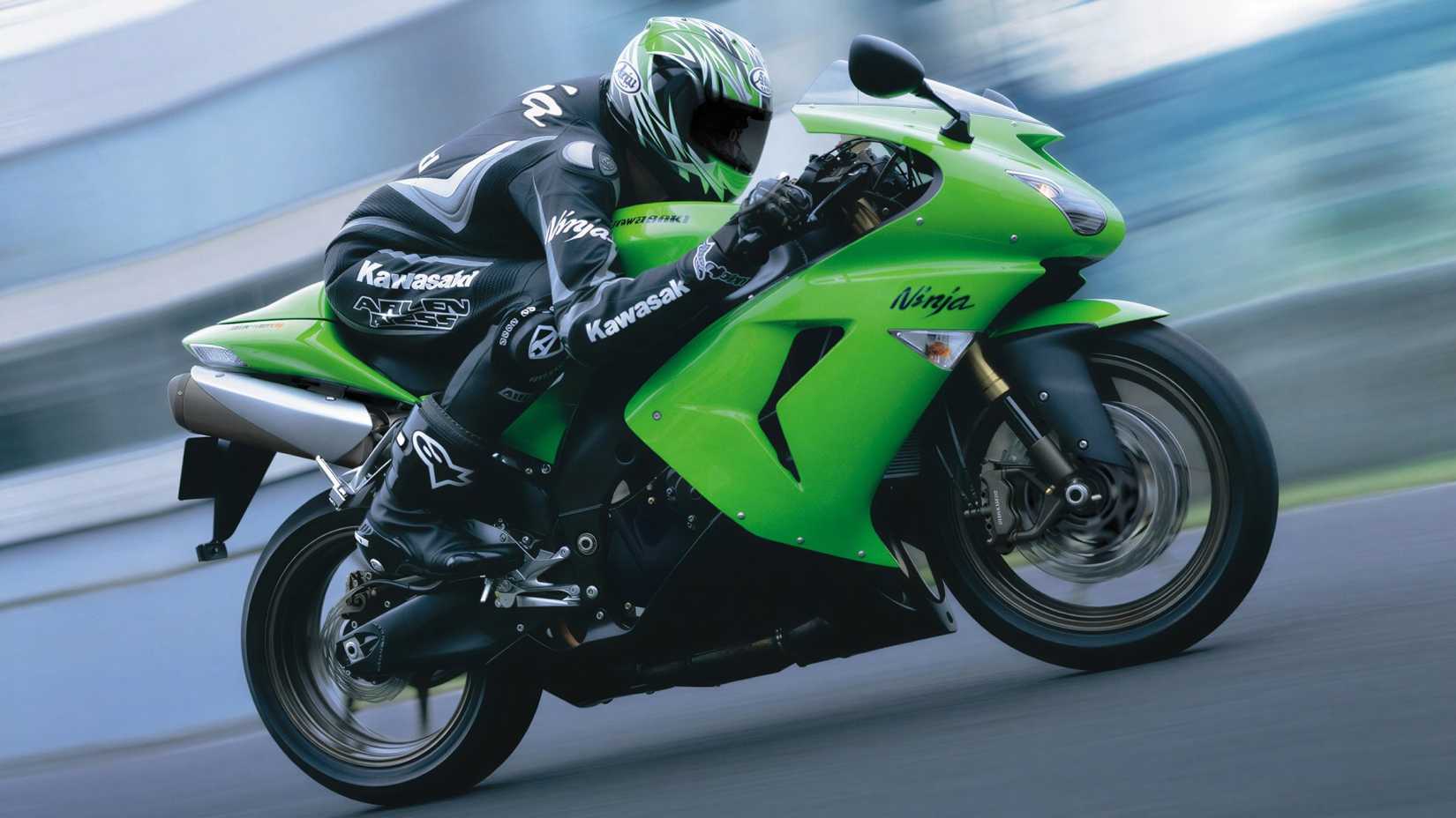 2006 Kawasaki Ninja ZX-10R accelerating hard on a racetrack side profile view