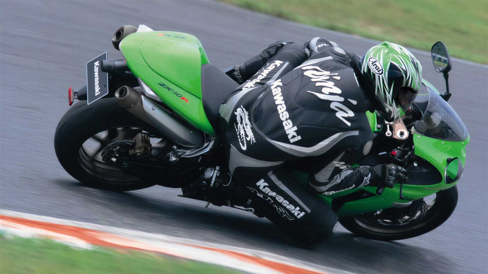 2006 Kawasaki Ninja ZX-10R cornering hard on a racetrack rear third quarter view