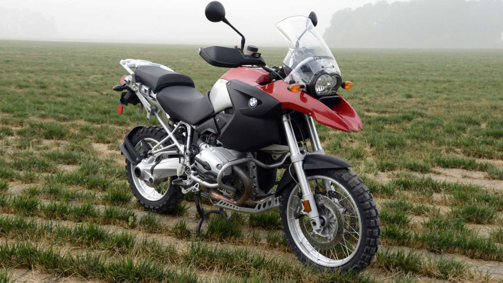 2005 BMW R1200GS in red and silver parked on an off-road patch