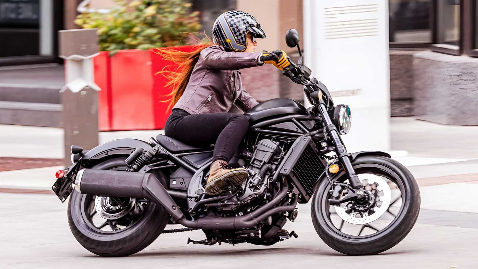 2026 Honda Rebel 1100 cruising smoothly on an urban road