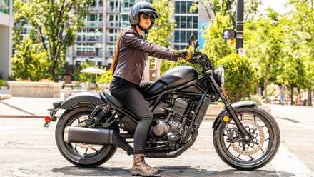 A short rider sitting on the Honda Rebel 1100 side profile cinematic shot