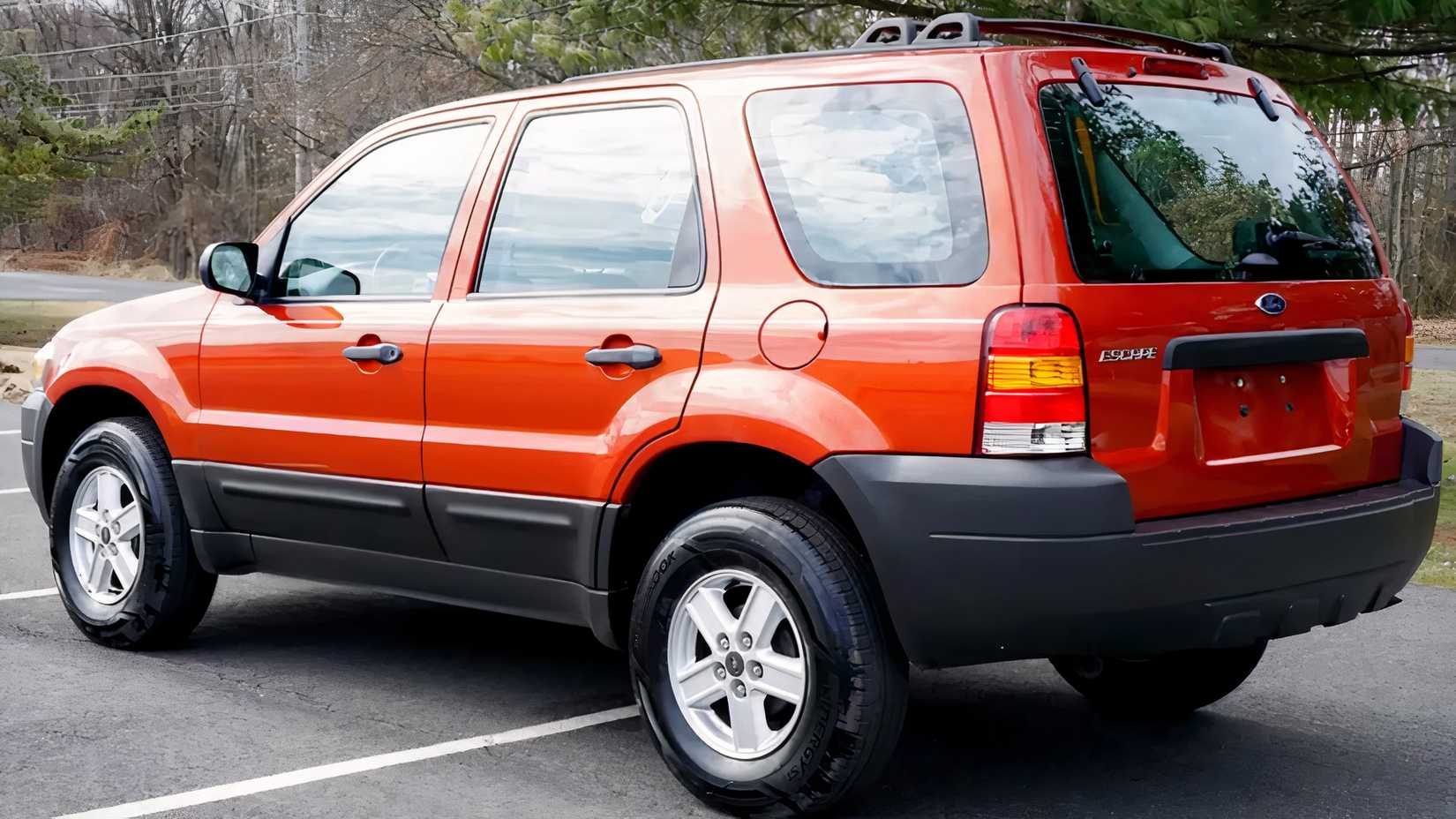 2007 Red Ford Escape Rear 3/4 shot parked in lot