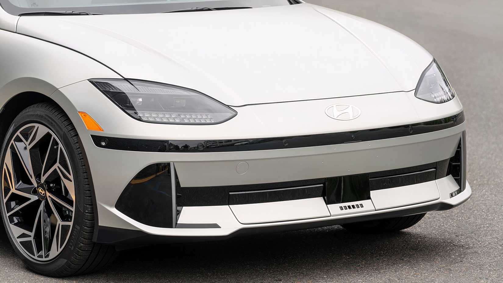 Close-up detail shot of a gray 2025 Hyundai Ioniq 6 showing the lower front fascia