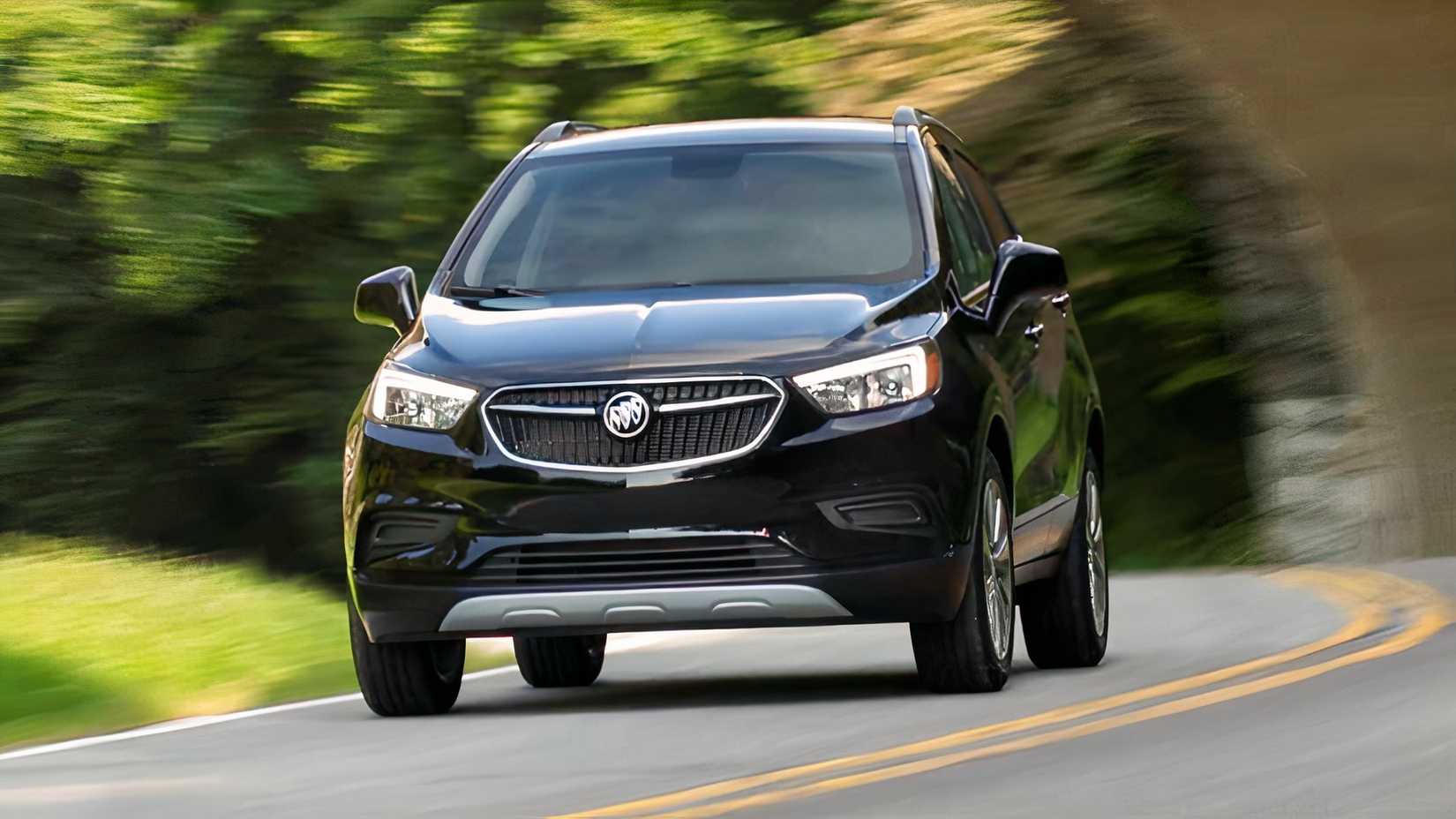 Front 3/4 action shot of 2021 Buick Encore Preferred in black driving on road