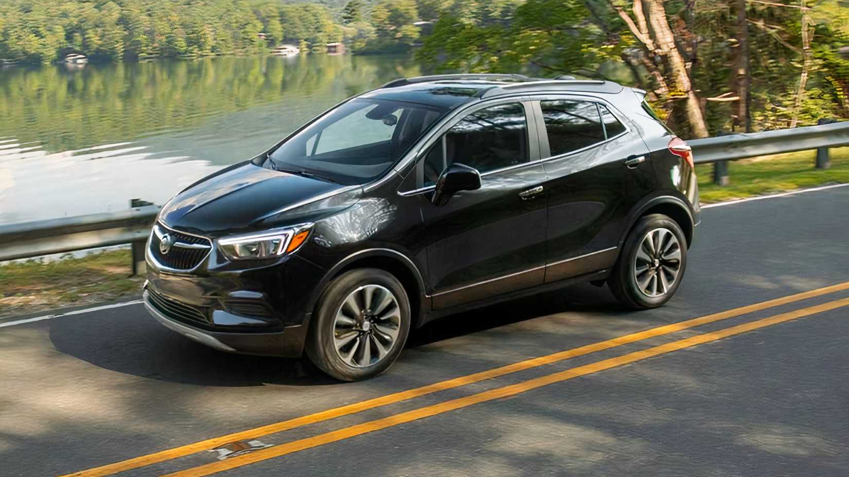 Front 3/4 action shot of 2021 Buick Encore Preferred in black driving on road