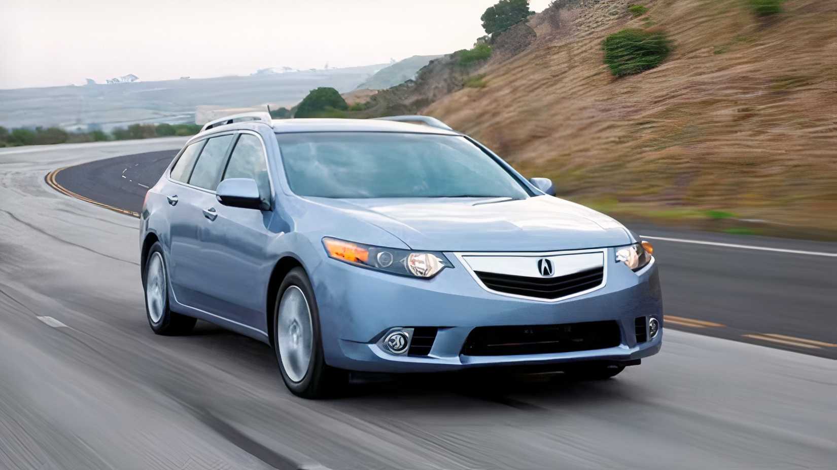 Front 3/4 action shot of 2014 Acura TSX Sport Wagon driving on road