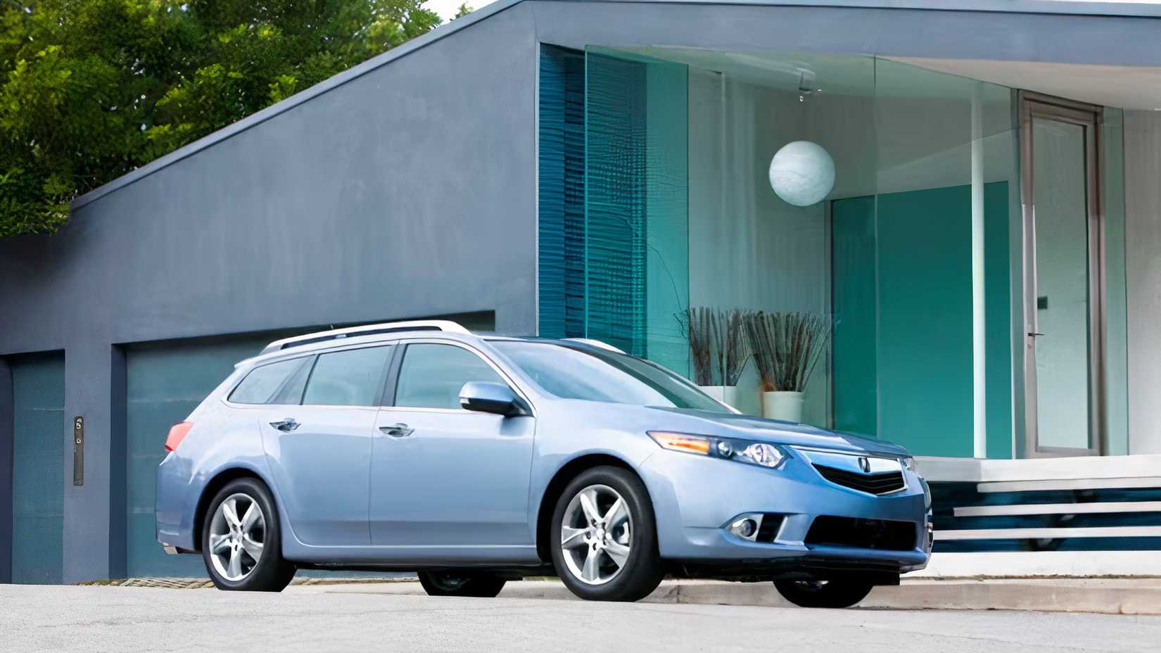 Front 3/4 shot of 2014 Acura TSX Sport Wagon parked in front of  house