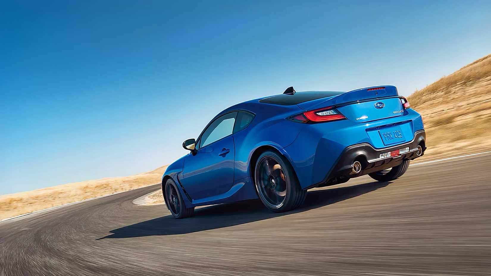Rear 3/4 action shot of 2026 Subaru BRZ driving on track