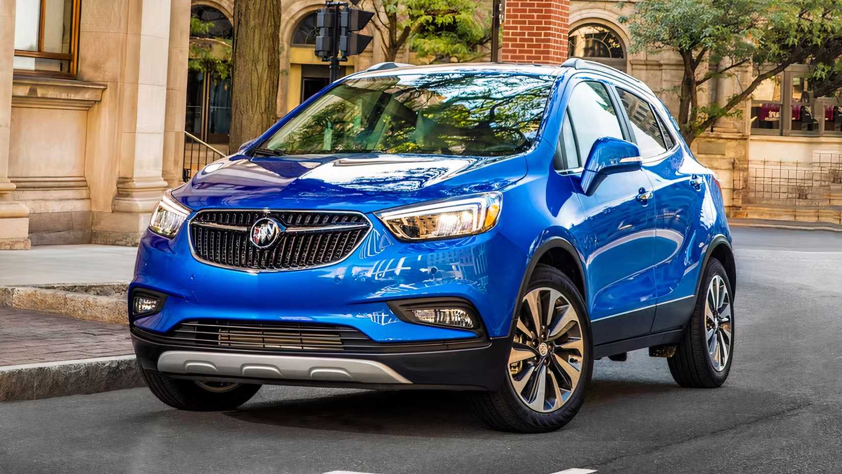 Front 3/4 action shot of 2021 Buick Encore in blue driving on road