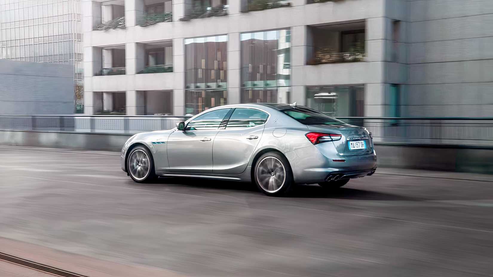Rear 3/4 action shot of 2024 Maserati Ghibli in silver driving on road