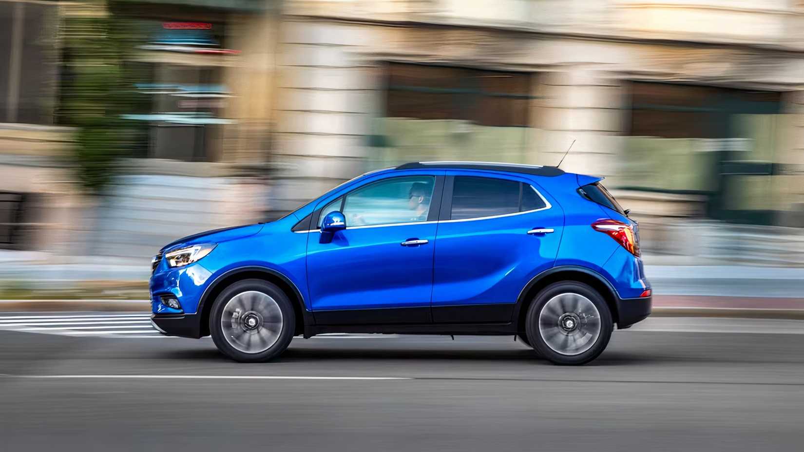 Profile action shot of 2021 Buick Encore in blue driving on road