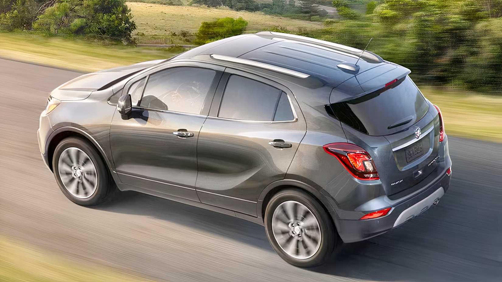 Rear 3/4 action shot of 2021 Buick Encore in silver driving