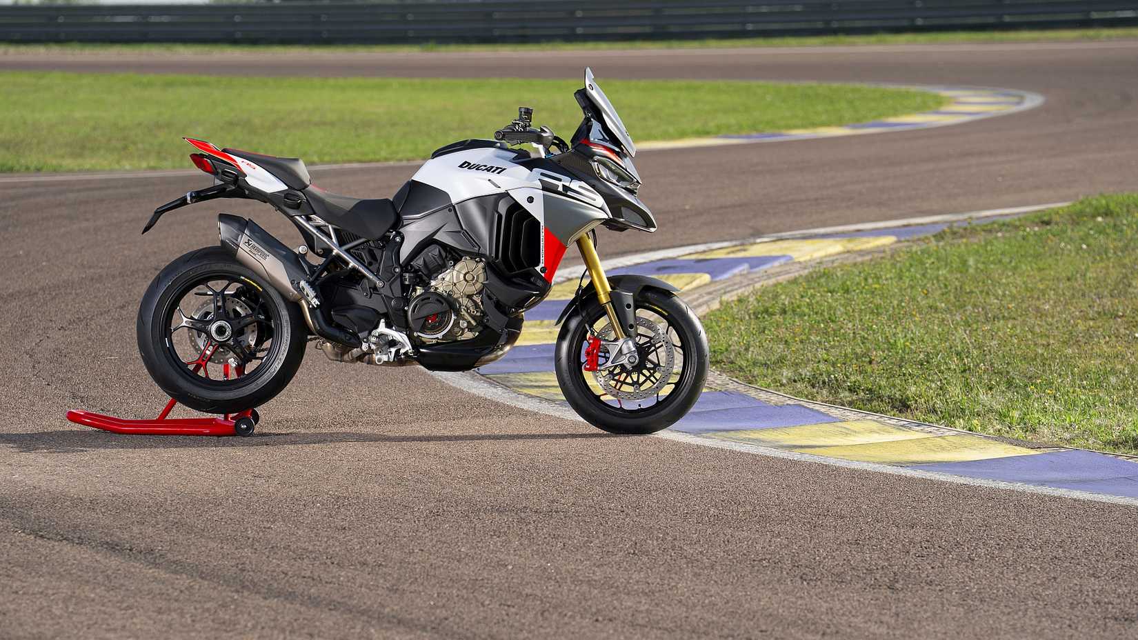 Uma Ducati Multistrada V4 RS estacionada em um paddock em uma chicane em uma pista de corrida