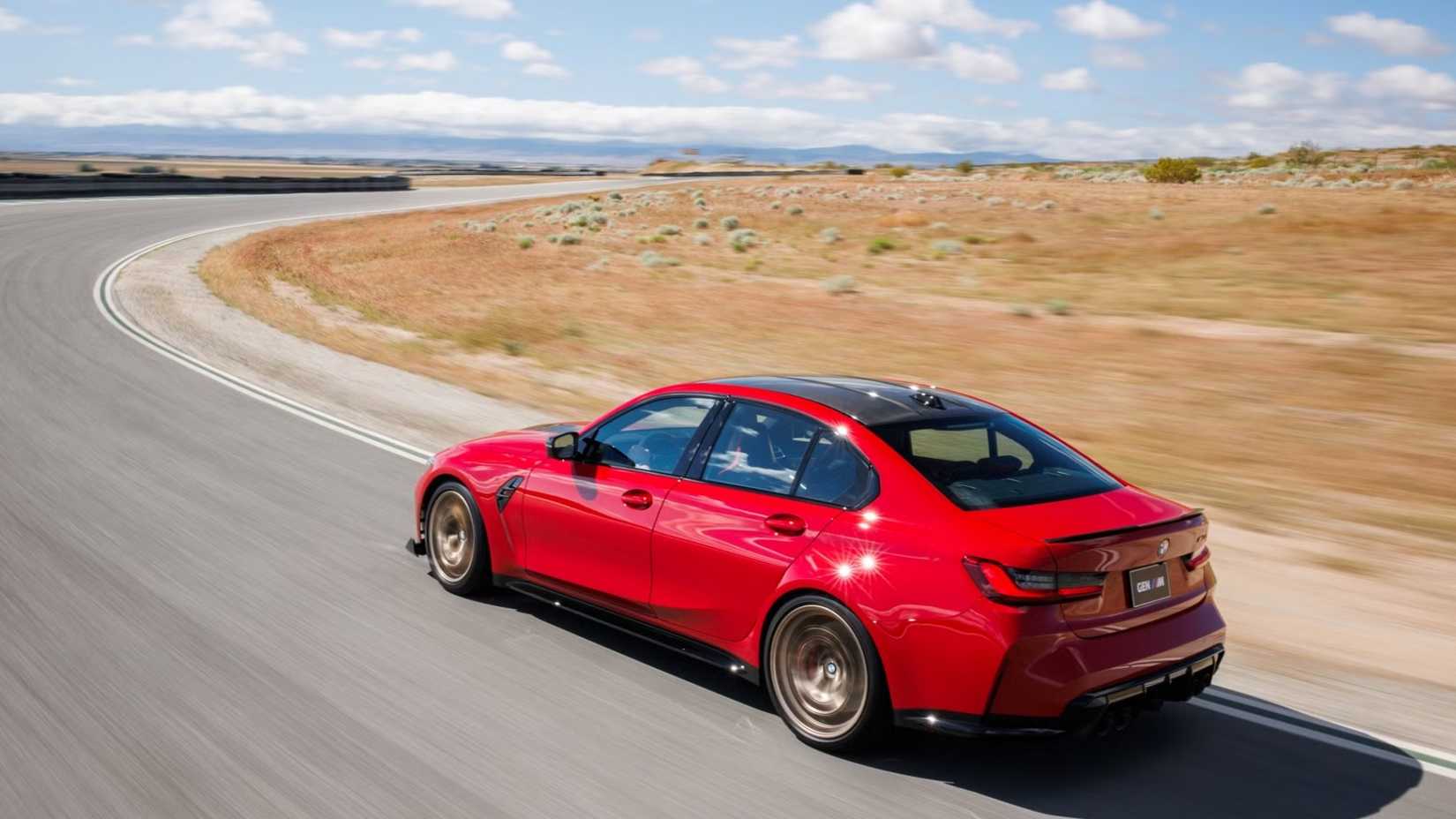 2027 BMW M3 CS Handschalter rear 3/4 shot driving on the road