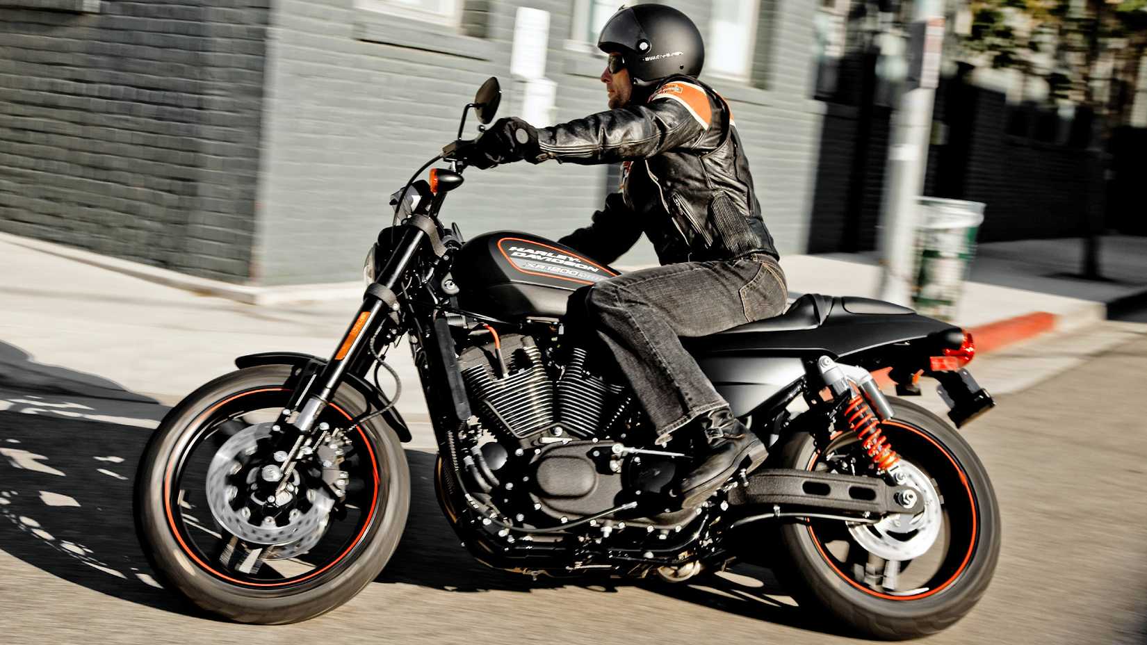 Piloto em uma Harley-Davidson XR1200X 2011 cruzando a cidade