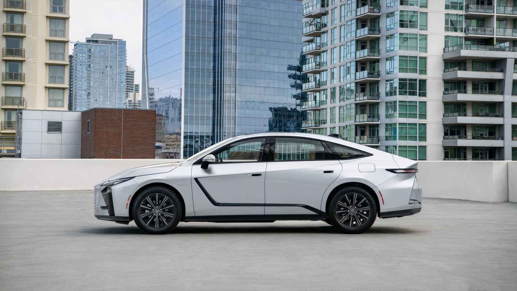 2026 Lexus ES 350h Premium Iridium Palomino side shot parked on rooftop lot