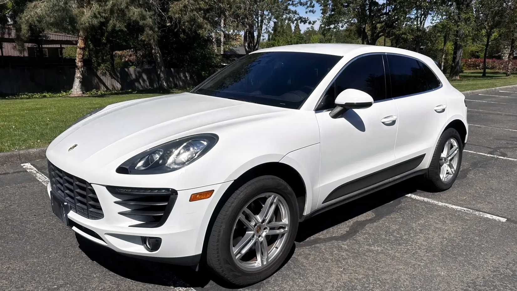 2016 white Porsche Macan S front shot parked in lot