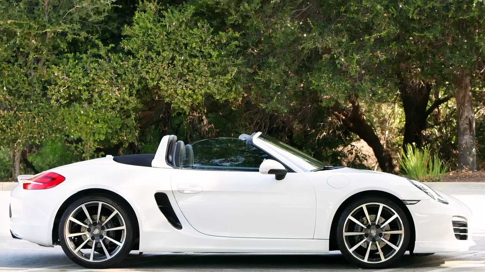 2013 white Porsche 918 Boxster Side shot parked on the road