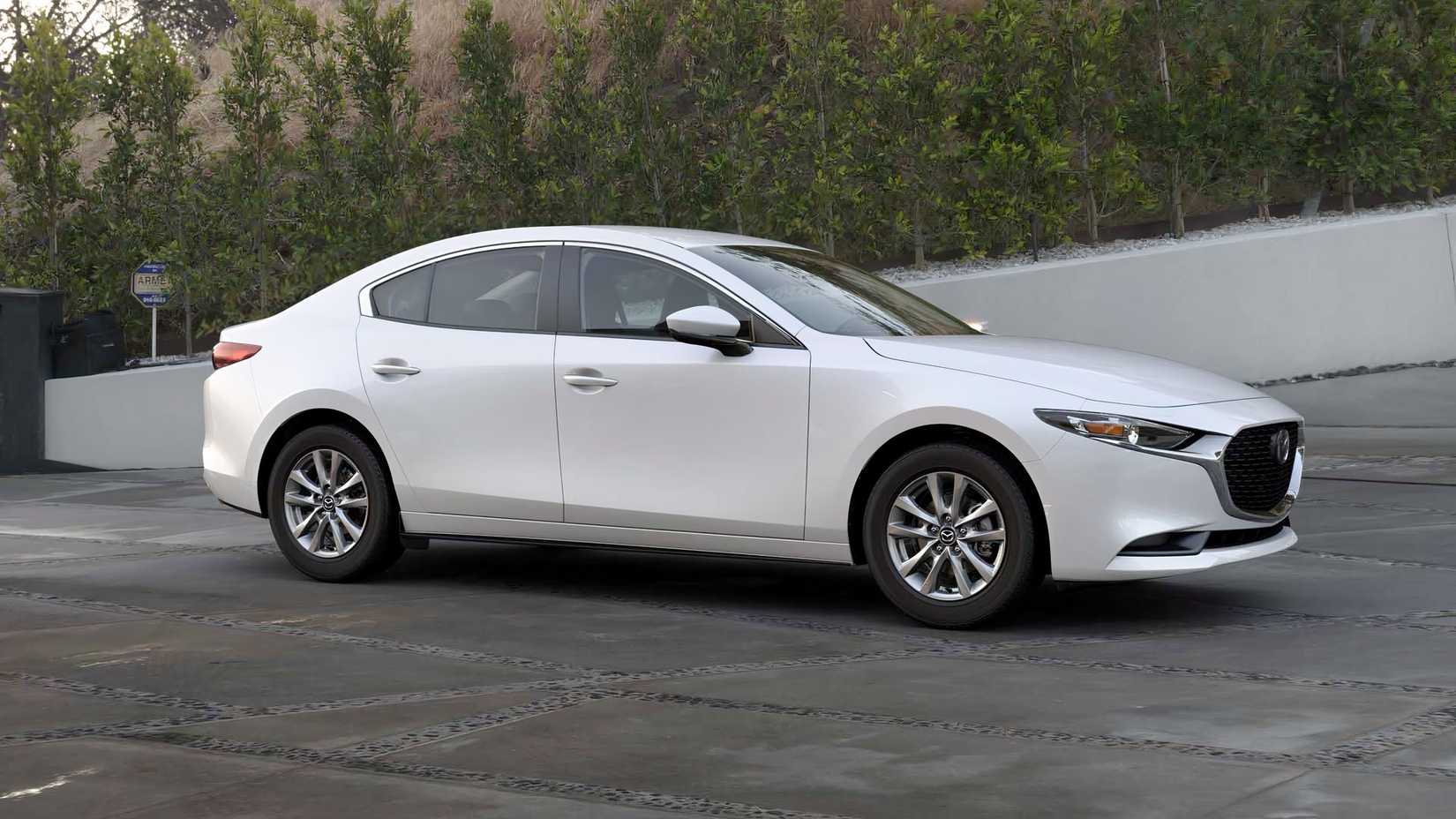 Profile shot of 2026 Mazda 3 Sedan in white parked