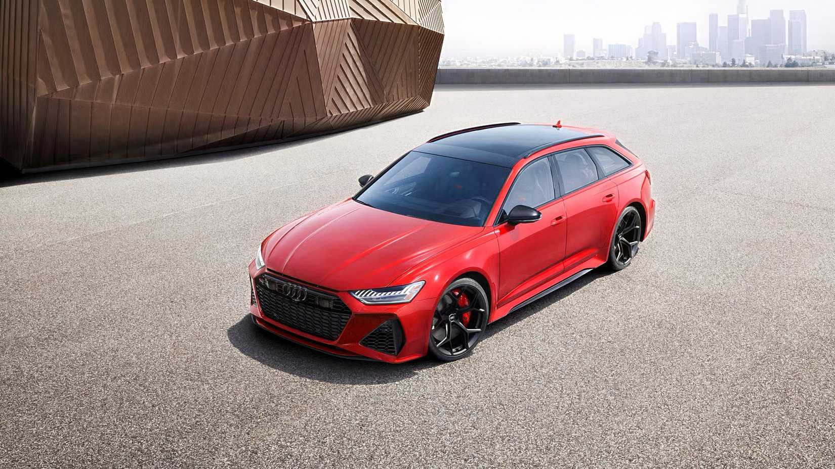 Front 3/4 shot of 2026 Audi RS6 Avant Performance in red parked