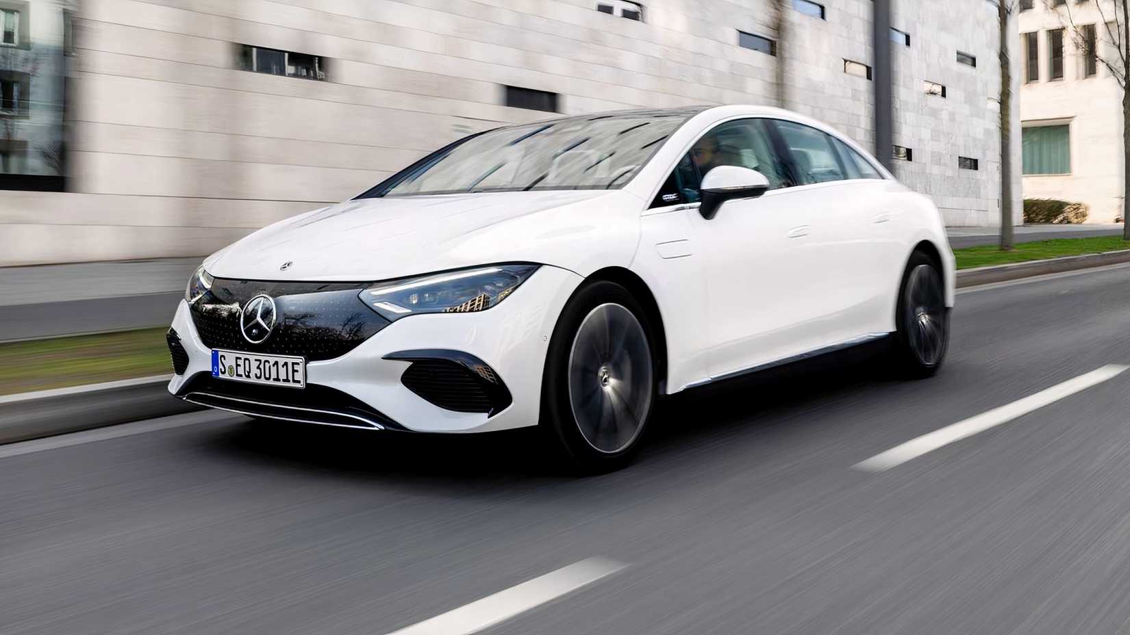 Front 3/4 action shot of 2026 Mercedes-Benz EQE 320+ driving on road